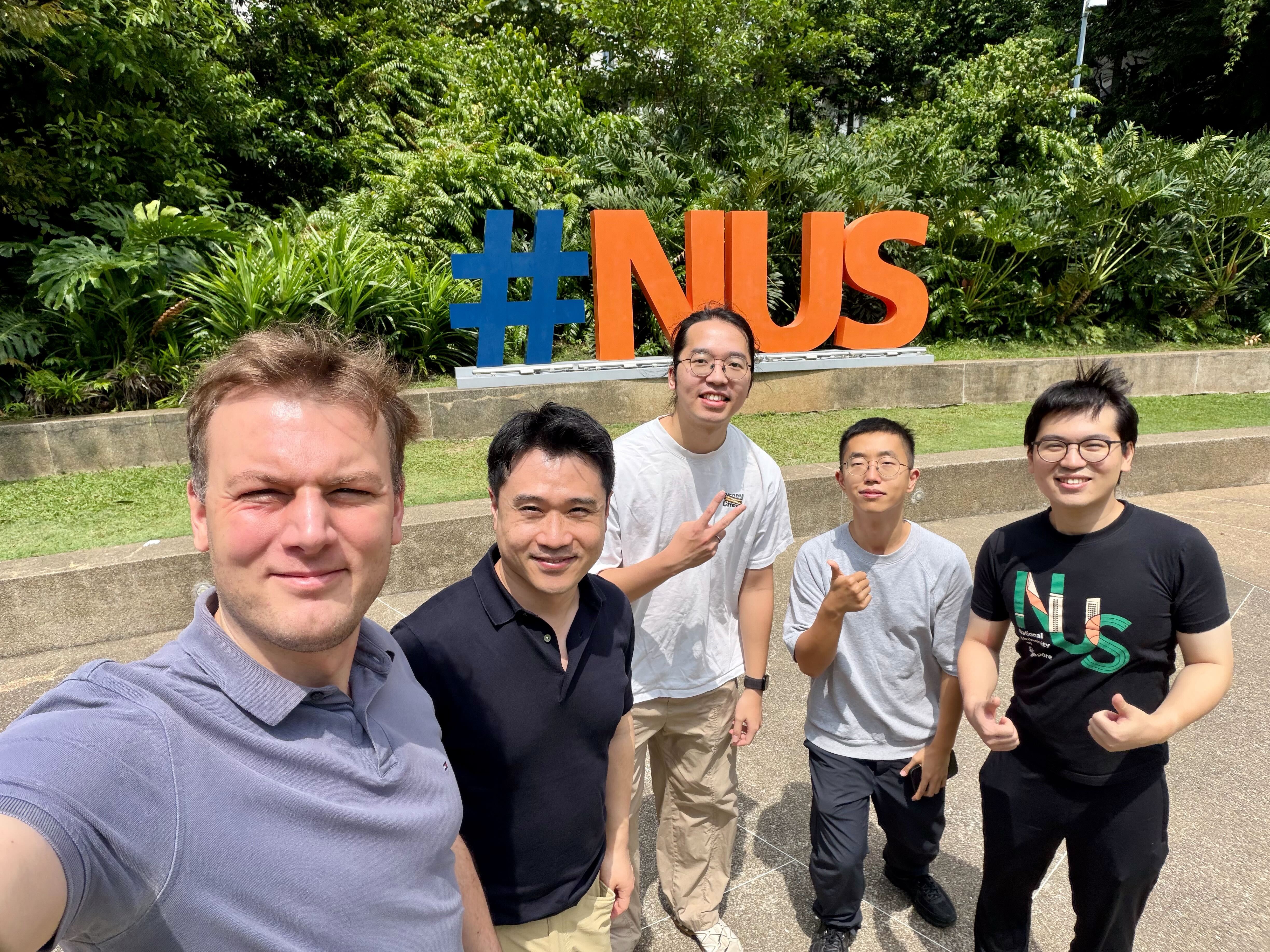 in front of NUS logo in UTown